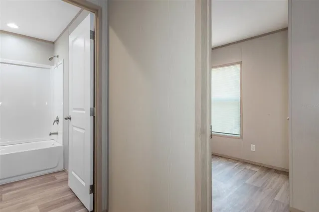 a view of bathroom with bathtub and shower