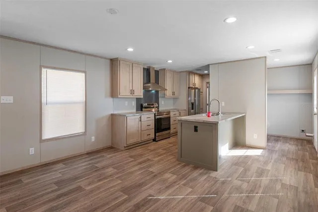 a kitchen with a sink cabinets and wooden floor