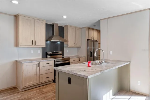a kitchen with stainless steel appliances granite countertop a sink stove and refrigerator