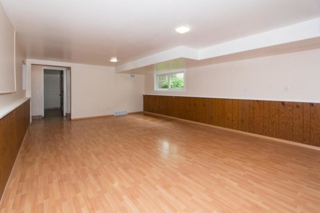 716 Ranch Road Wheaton, IL 60187 - Photo 15 of 24 a view of an empty room with wooden floor and a window