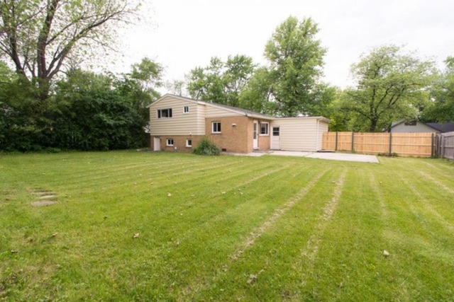 716 Ranch Road Wheaton, IL 60187 - Photo 20 of 24 a view of a house with a yard and a large tree