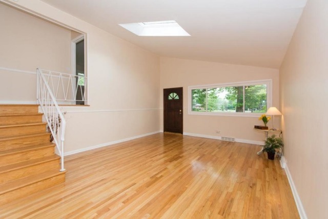 716 Ranch Road Wheaton, IL 60187 - Photo 4 of 24 a view of a room with wooden floor and white walls
