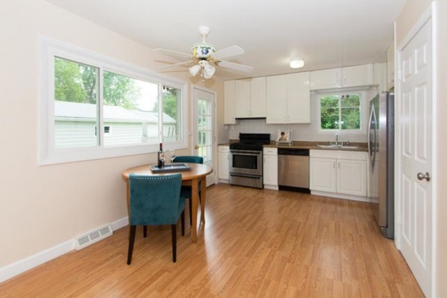 716 Ranch Road Wheaton, IL 60187 - Photo 6 of 24 a kitchen with a stove a sink and a refrigerator