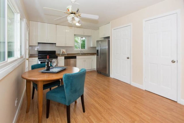 716 Ranch Road Wheaton, IL 60187 - Photo 7 of 24 a kitchen with stainless steel appliances a dining table chairs and a refrigerator