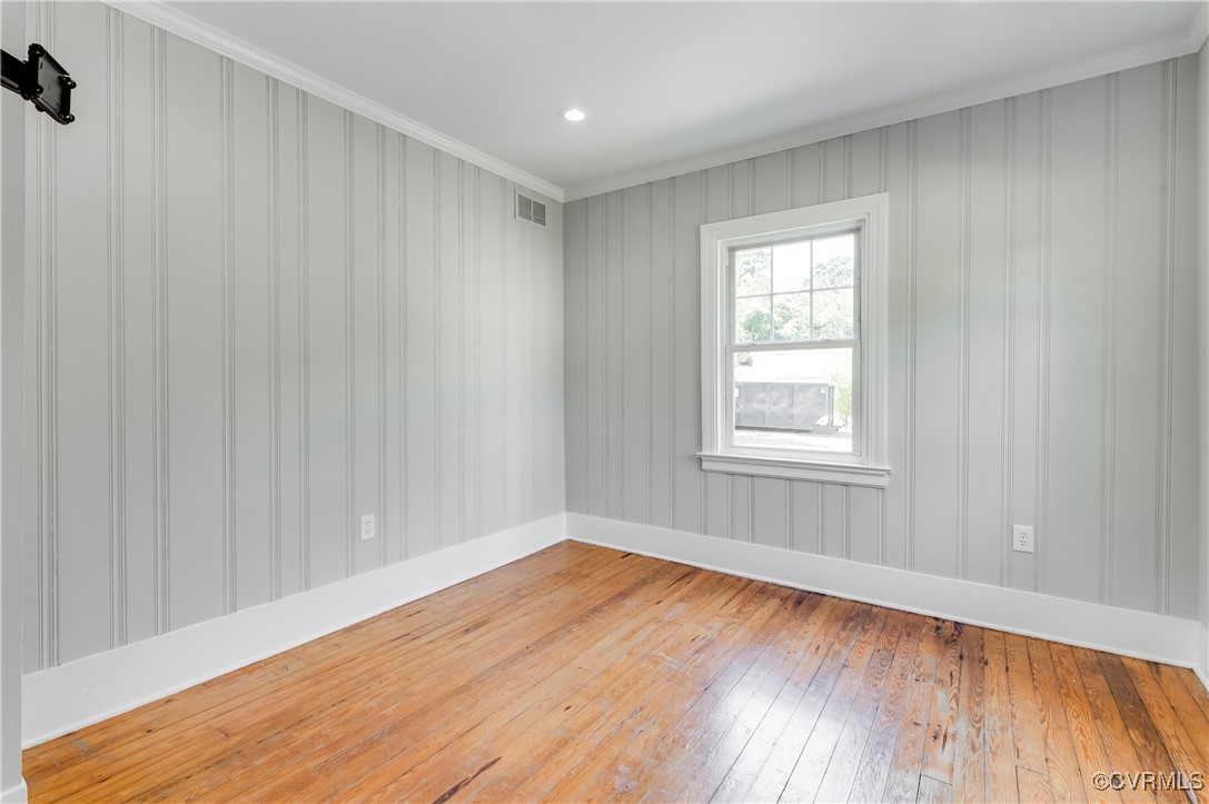 2821 Dumbarton Road Henrico, VA 23228 - Photo 25 of 37 Empty room featuring hardwood floors and crown mol