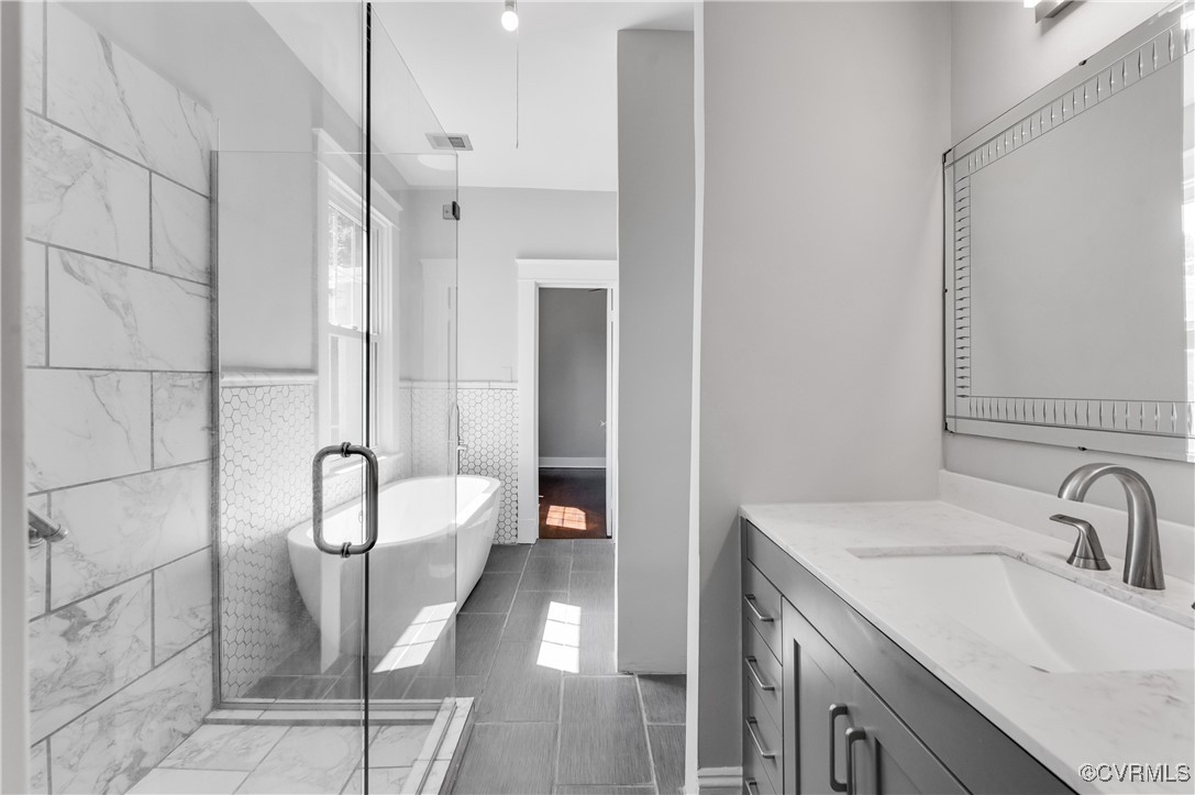 2821 Dumbarton Road Henrico, VA 23228 - Photo 10 of 37 Bathroom featuring vanity, tile walls, and shower