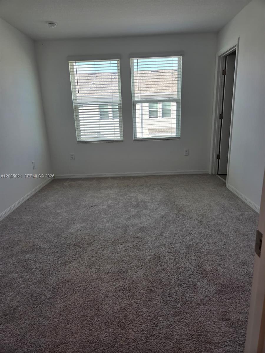3230 Skyline Loop, Unit 3230 Kissimmee, FL 34758 - Photo 6 of 8 an empty room with a window