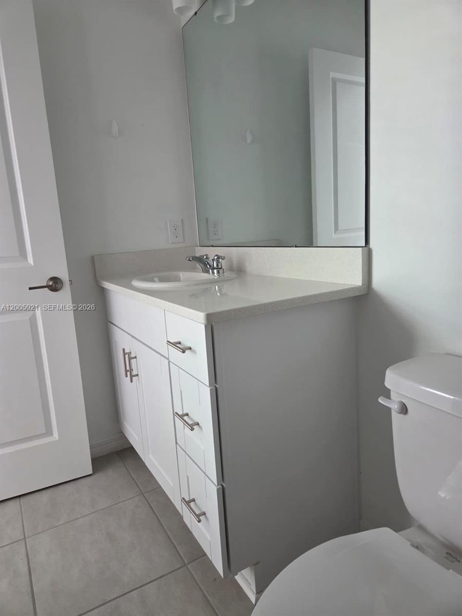 3230 Skyline Loop, Unit 3230 Kissimmee, FL 34758 - Photo 8 of 8 a bathroom with a toilet sink and mirror