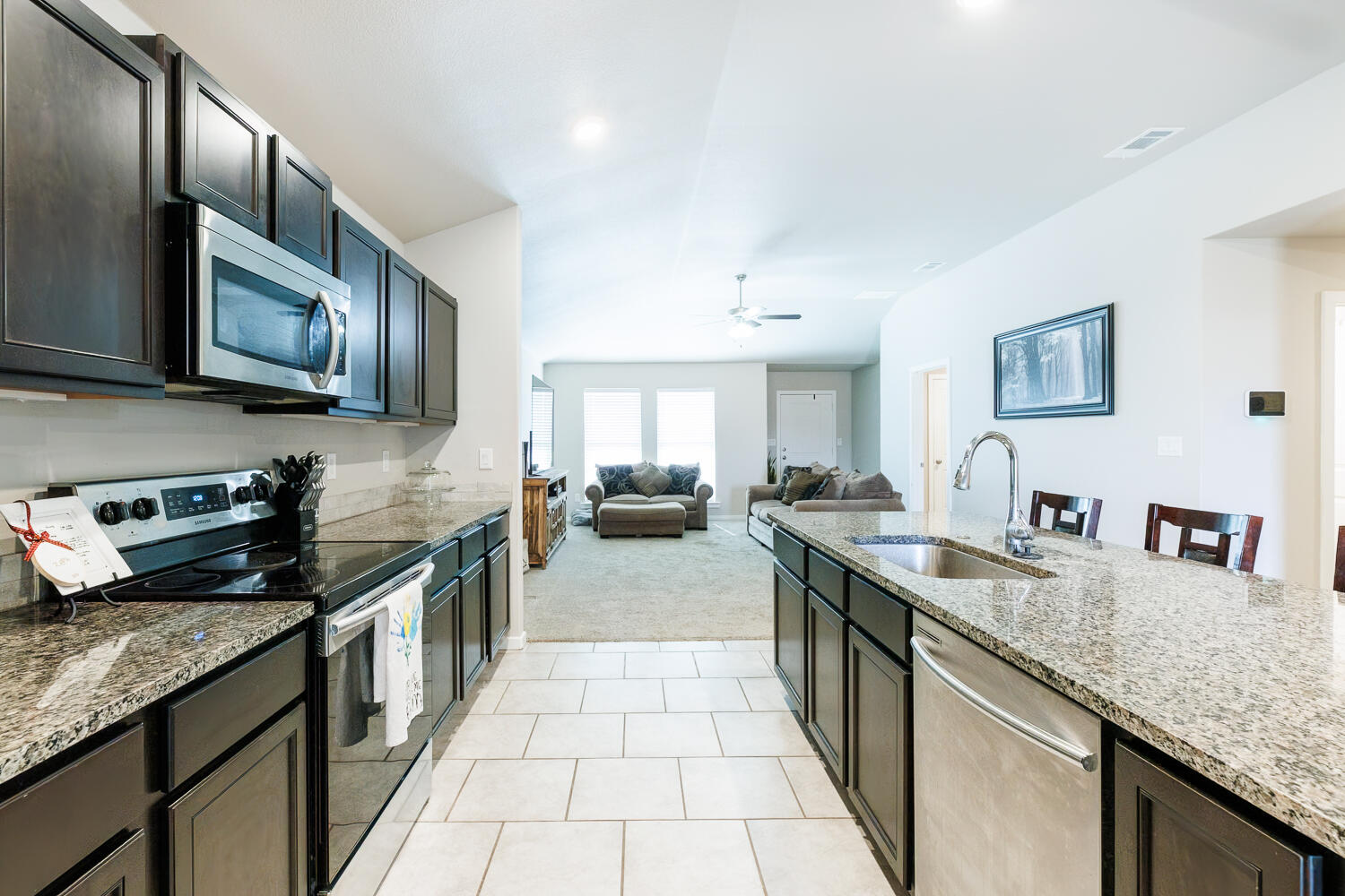 7322 29th Street Lubbock, TX 79407 - Photo 40 of 40 a kitchen with stainless steel appliances granite countertop a sink stove and cabinets