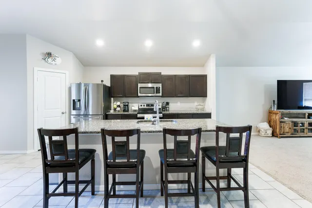 a kitchen with stainless steel appliances a refrigerator stove microwave and cabinets