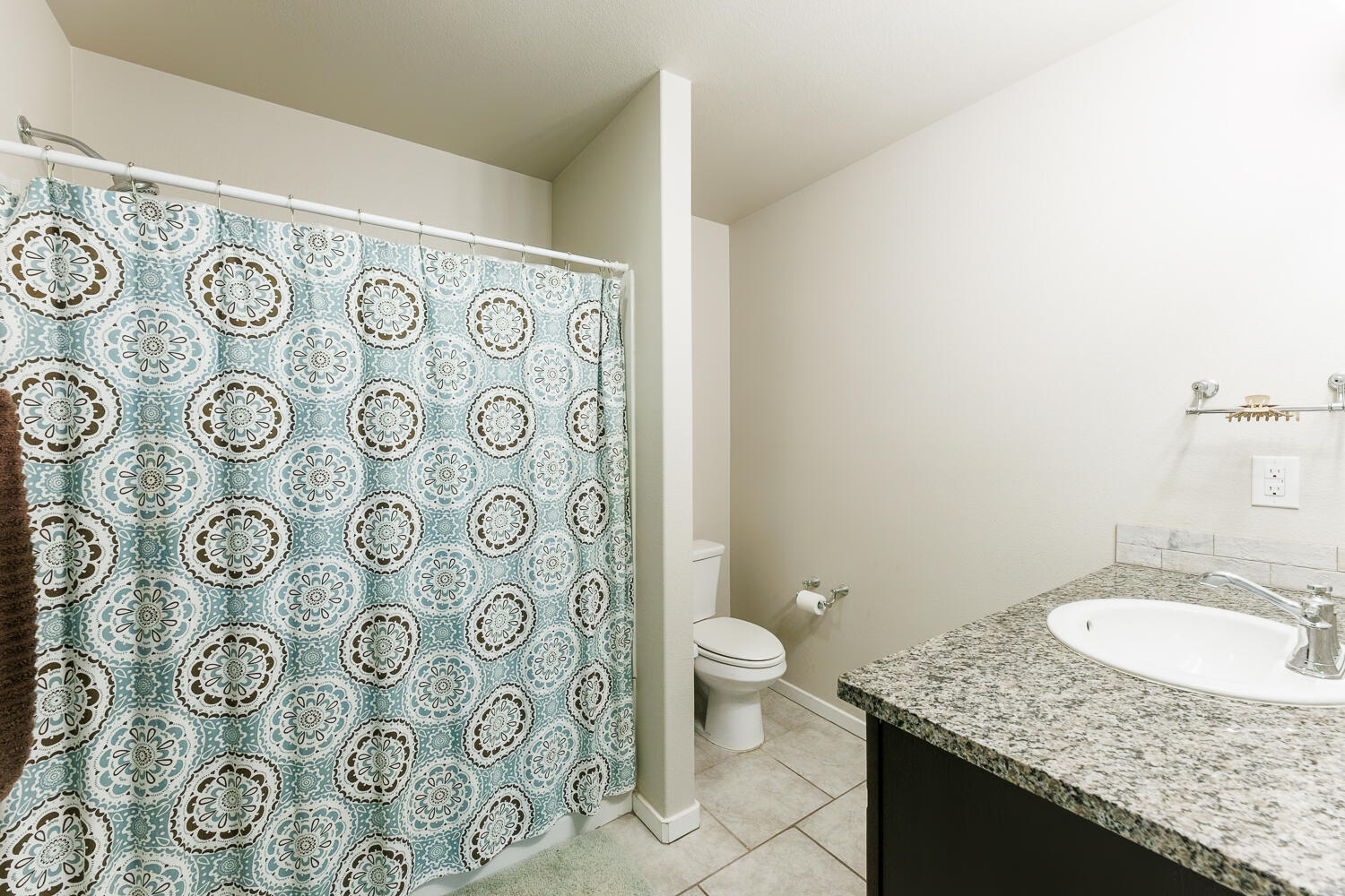 7322 29th Street Lubbock, TX 79407 - Photo 20 of 40 a bathroom with a granite countertop sink toilet and shower