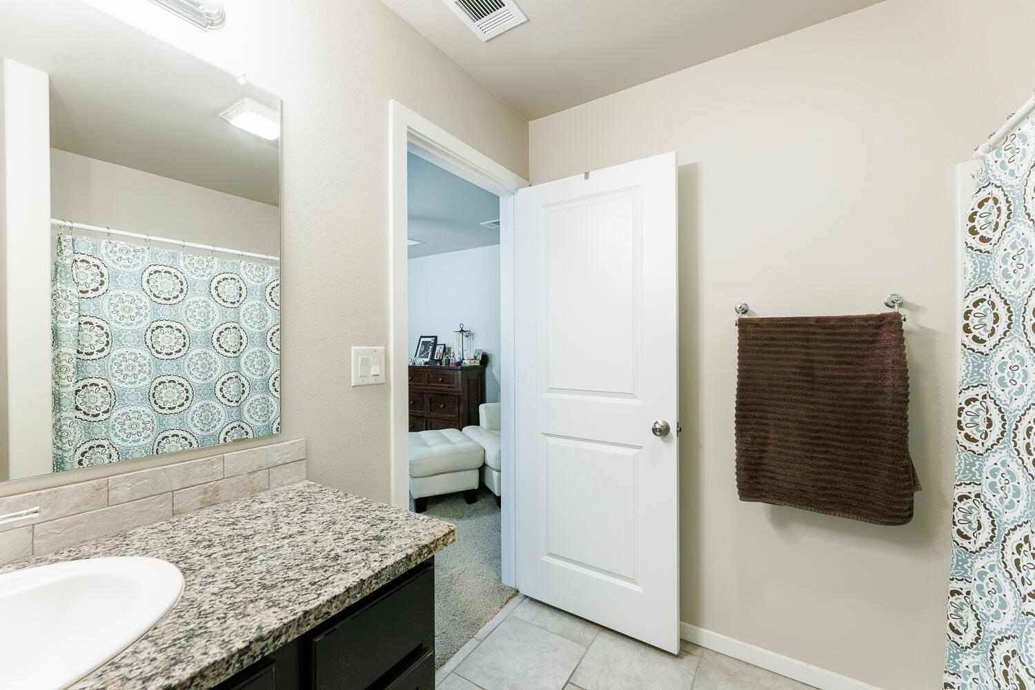 7322 29th Street Lubbock, TX 79407 - Photo 22 of 40 a bathroom with a granite countertop shower and a sink
