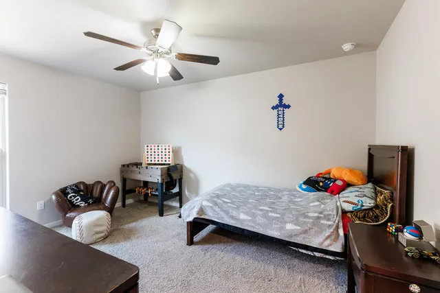 a bedroom with furniture and a chandelier