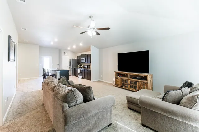 a living room with furniture and a flat screen tv
