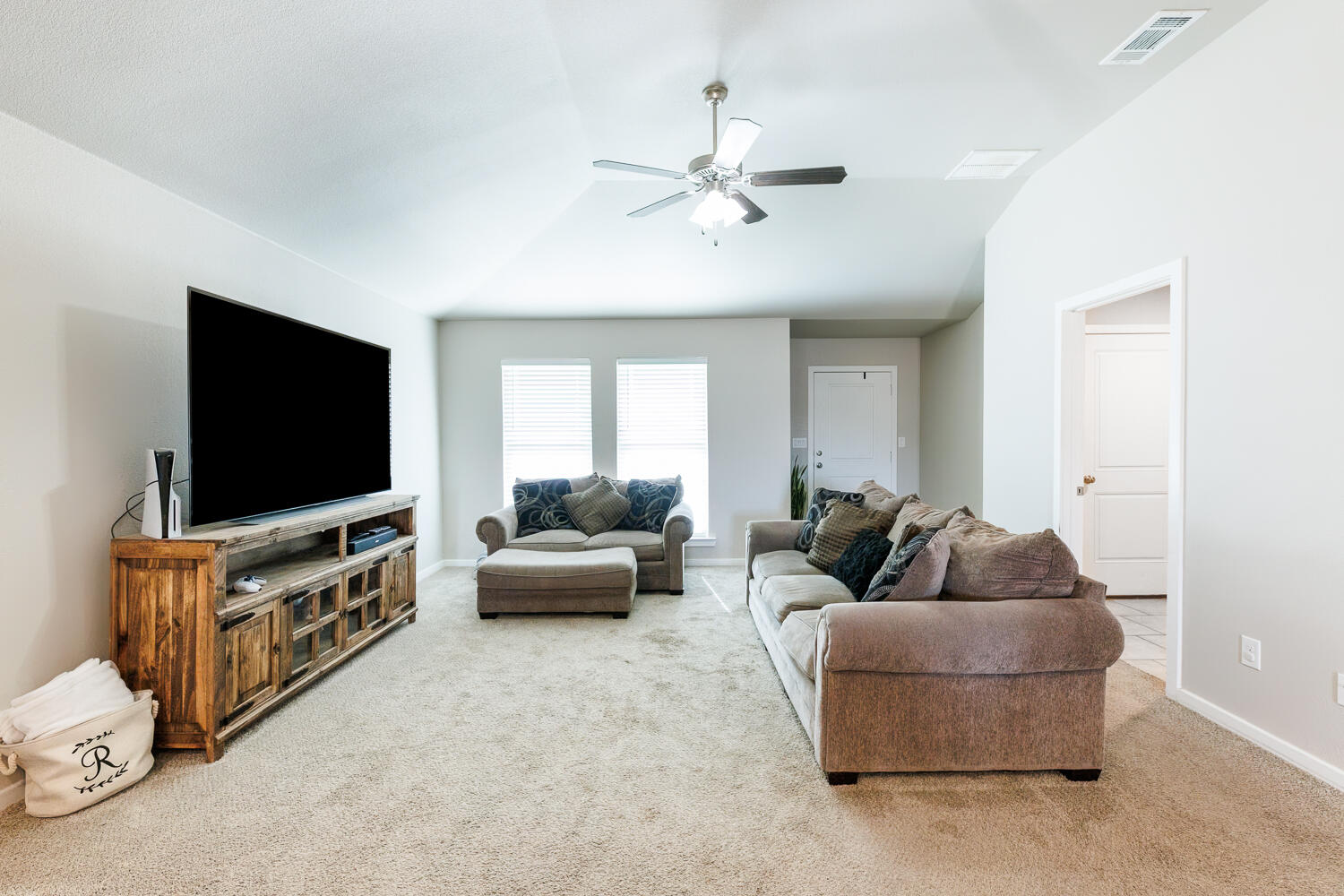 7322 29th Street Lubbock, TX 79407 - Photo 7 of 40 a living room with furniture and a flat screen tv