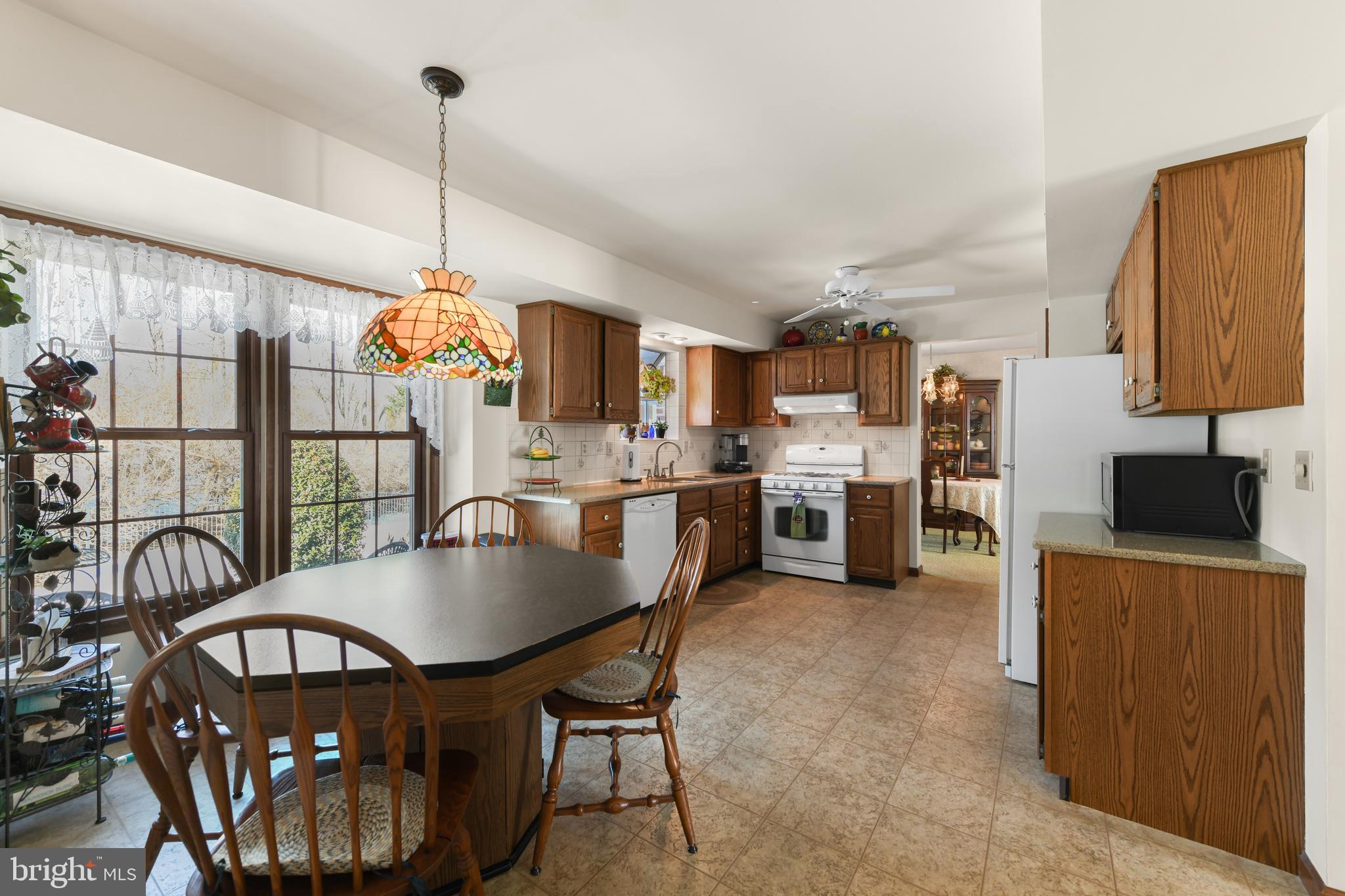 13 Marie Drive Sinking Spring, PA 19608 - Photo 15 of 55 a kitchen with stainless steel appliances a table chairs and a wooden floor