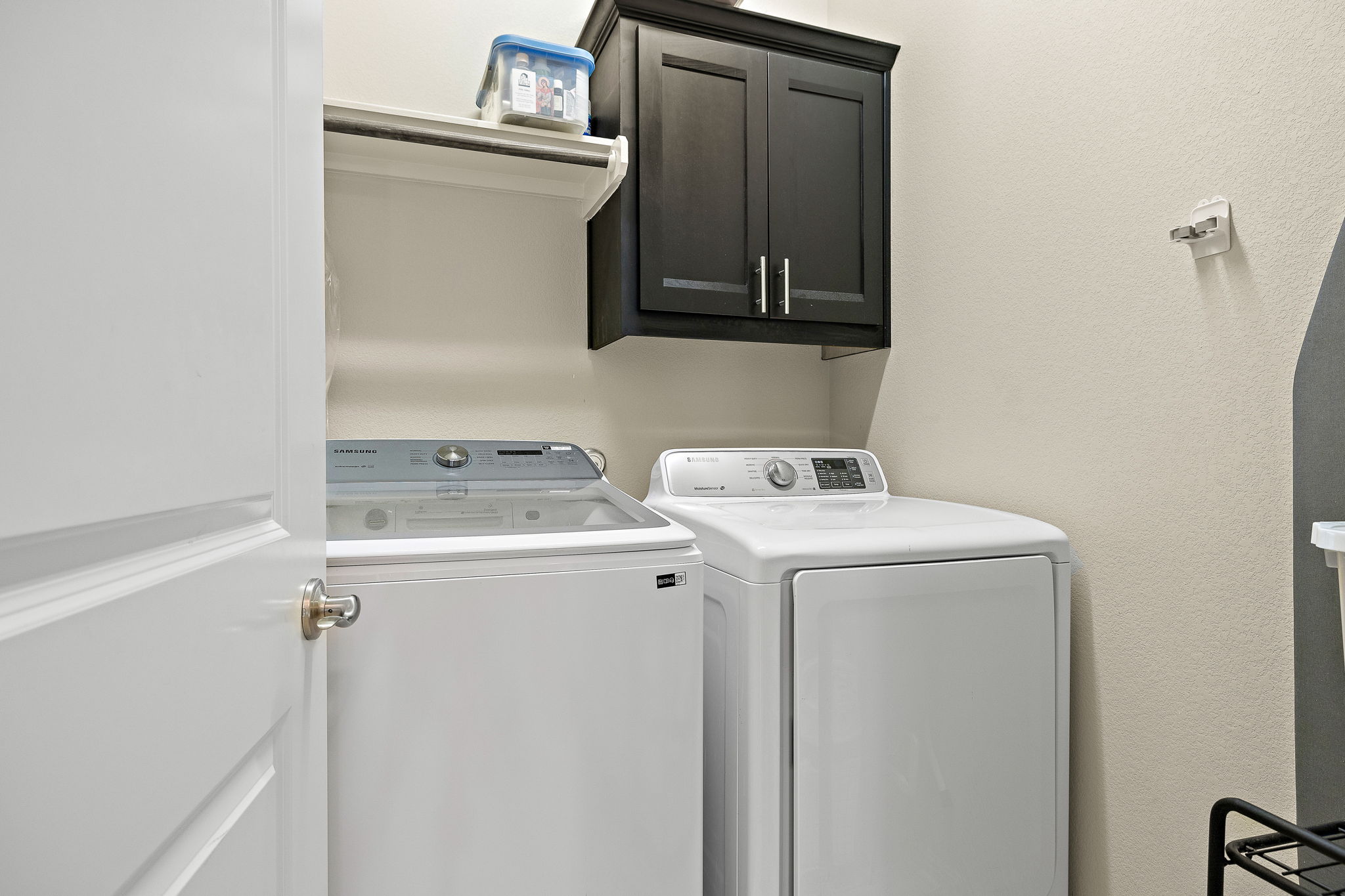 4413 Tambre Bend Austin, TX 78738 - Photo 17 of 30 Laundry room featuring a textured wall, cabinet space, and washer and dryer