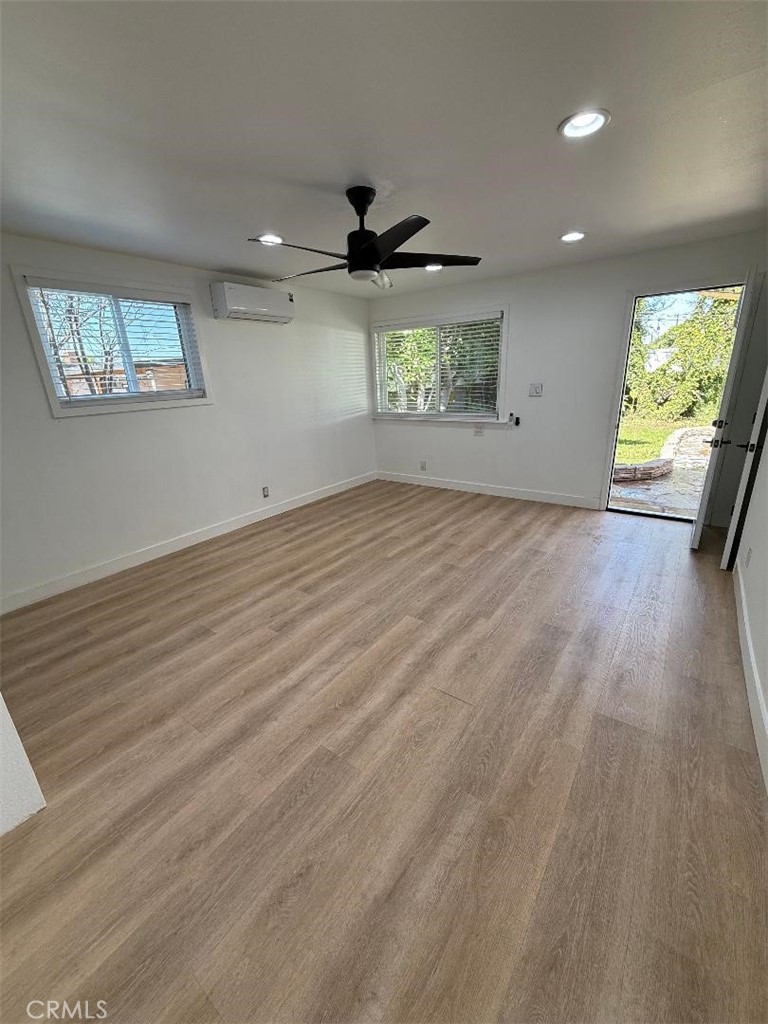 14352 A Flomar Drive Whittier, CA 90603 - Photo 2 of 10 an empty room with wooden floor and windows