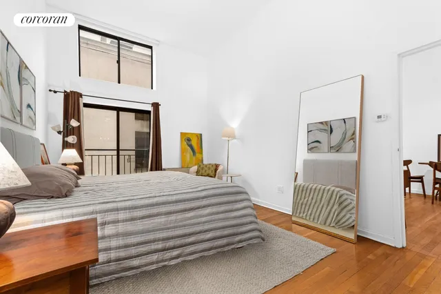 a living room with furniture a rug and a window