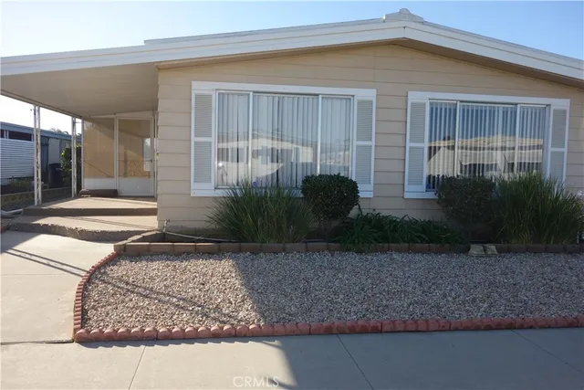 a view of a house with a small yard and plants