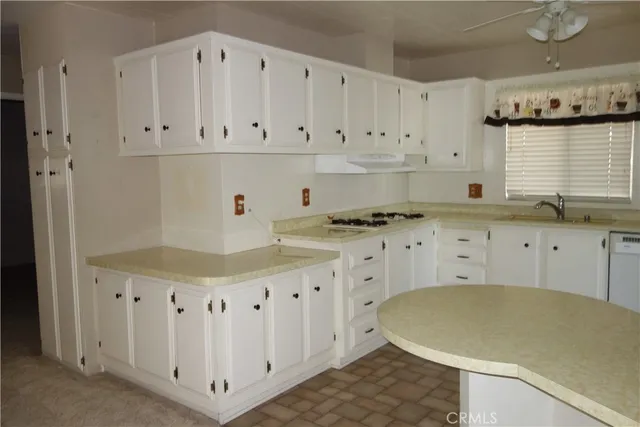 a bathroom with a granite countertop sink a toilet and shower