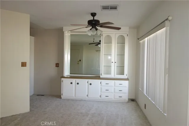 a view of an empty room and a window