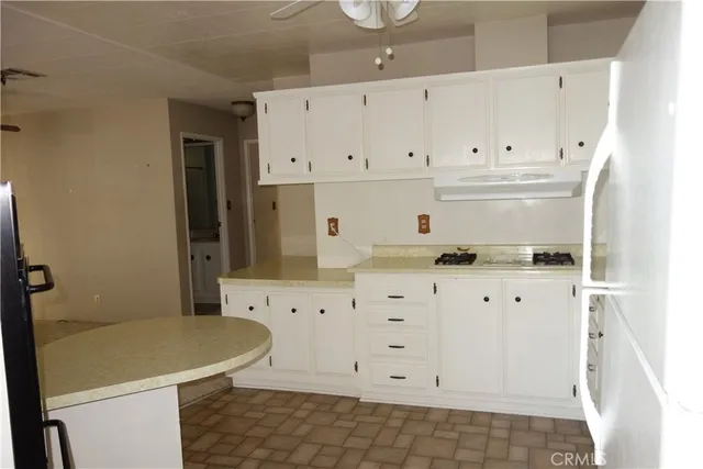 a kitchen with stainless steel appliances granite countertop a sink a stove and a refrigerator