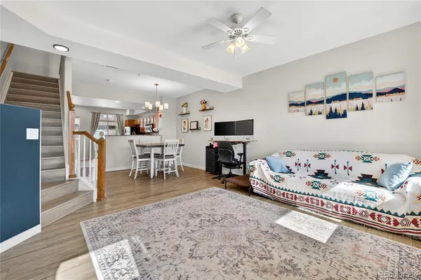 a living room with furniture and wooden floor