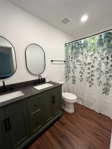 a bathroom with a toilet a sink and a mirror