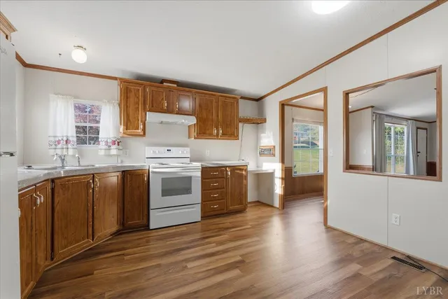 a kitchen with stainless steel appliances a stove top oven and a refrigerator