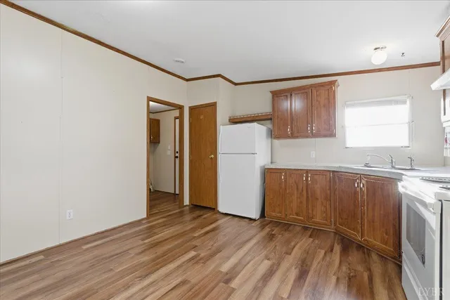 a view of a kitchen with wooden floor and a sink