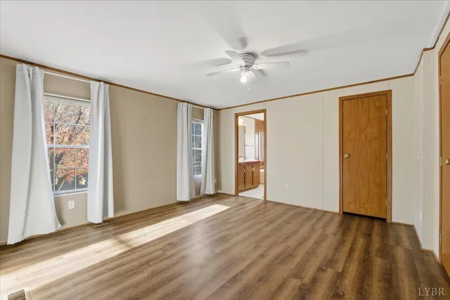 a view of a big room with wooden floor and windows in a room