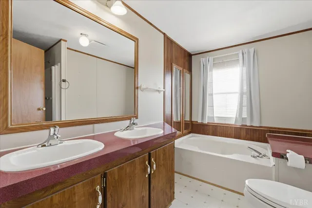 a bathroom with a tub sink and mirror