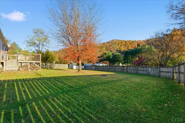 a view of yard with swimming pool and trees
