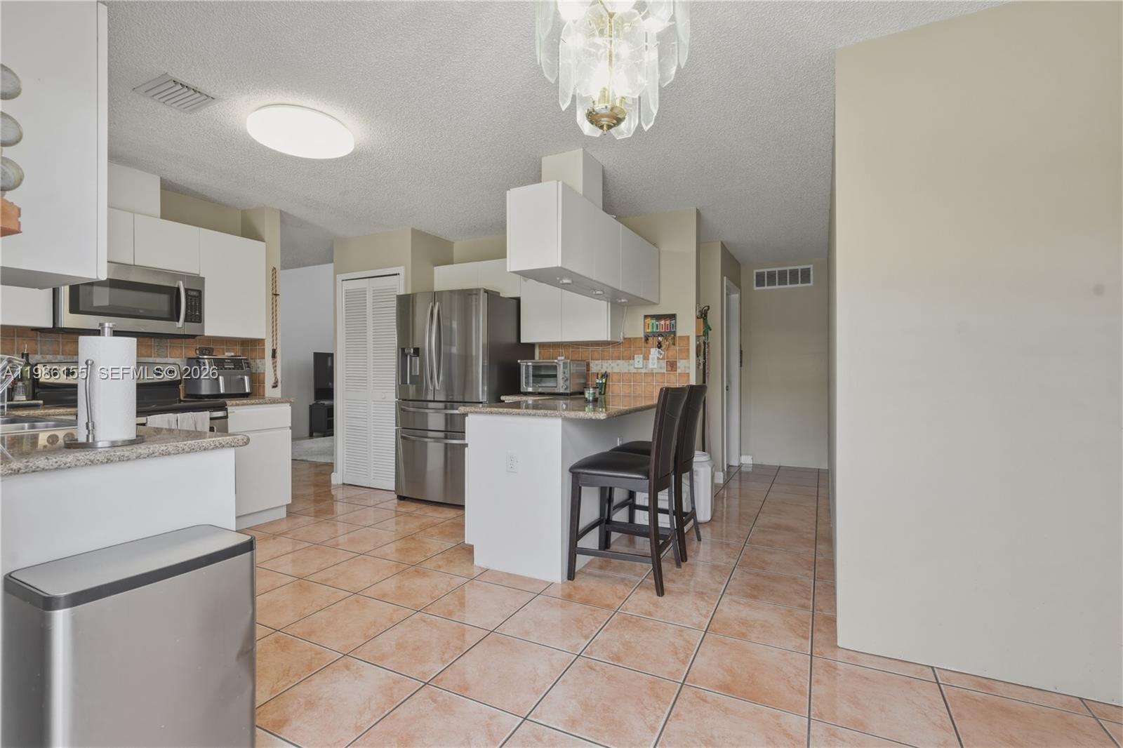 13237 Northwest 11th Terrace Miami, FL 33182 - Photo 18 of 39 Kitchen and entry way to 1/2 bathroom