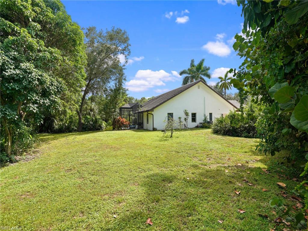 2140 Harlans Run Naples, FL 34105 - Photo 11 of 37 a view of a house with backyard and garden