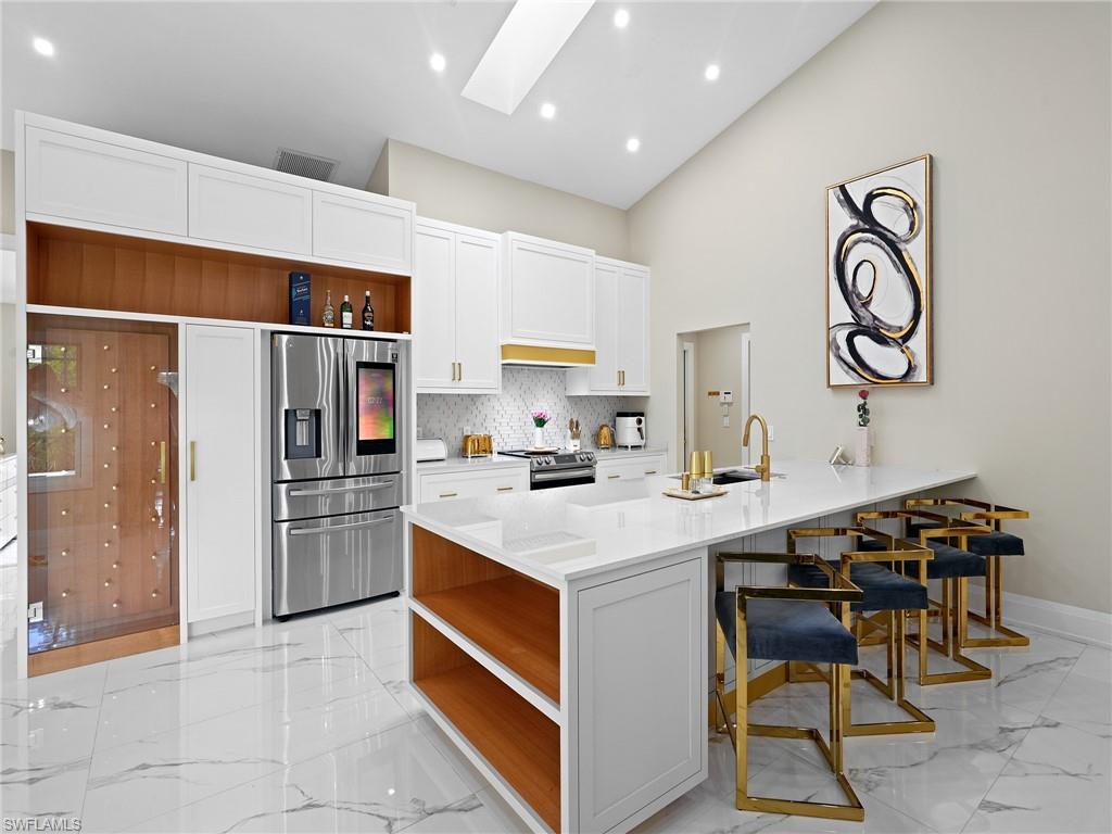 2140 Harlans Run Naples, FL 34105 - Photo 17 of 37 a kitchen with a refrigerator and a stove top oven