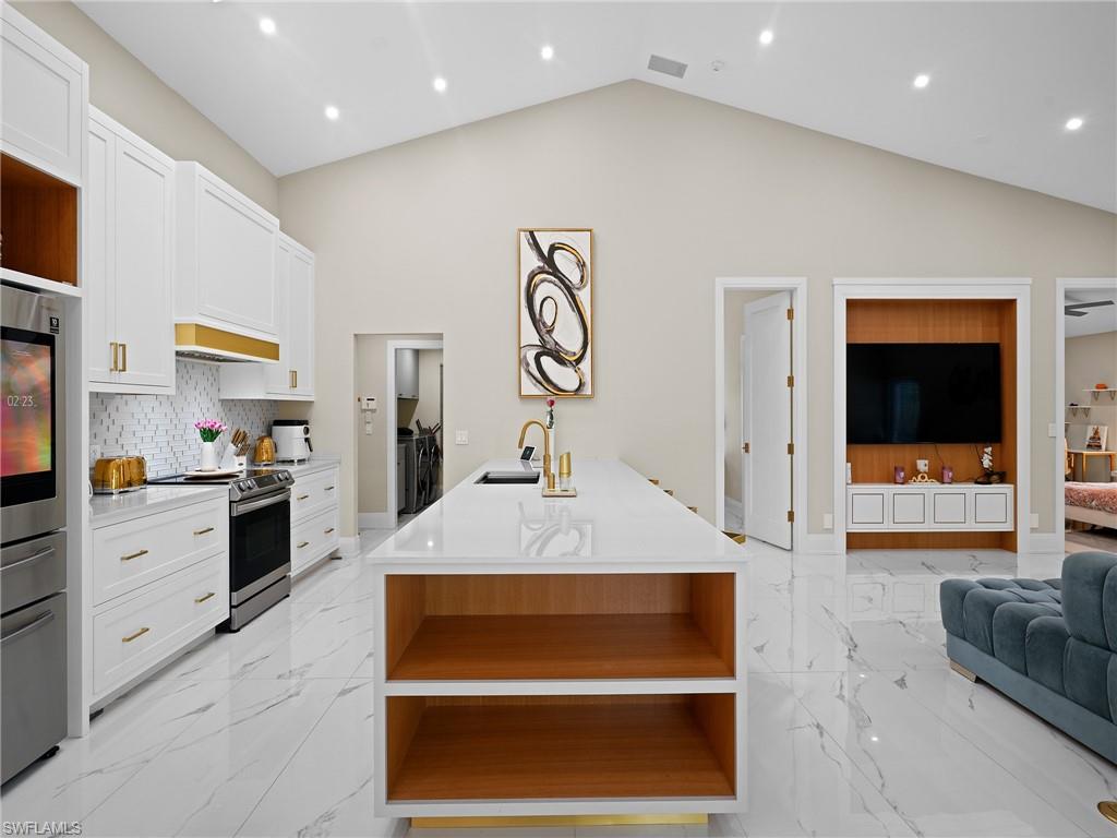 2140 Harlans Run Naples, FL 34105 - Photo 18 of 37 a large white kitchen with cabinets