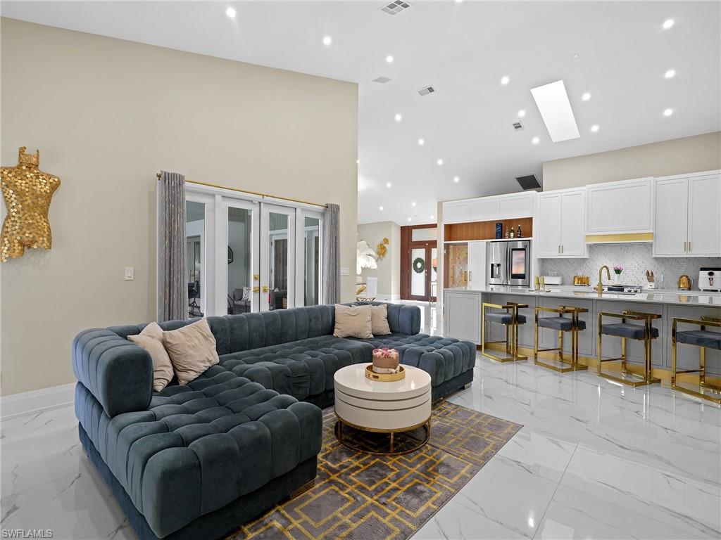2140 Harlans Run Naples, FL 34105 - Photo 24 of 37 a living room with lots of furniture and view of kitchen