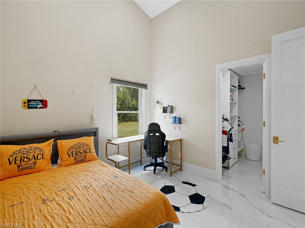 2140 Harlans Run Naples, FL 34105 - Photo 28 of 37 a bedroom with a bed and a window