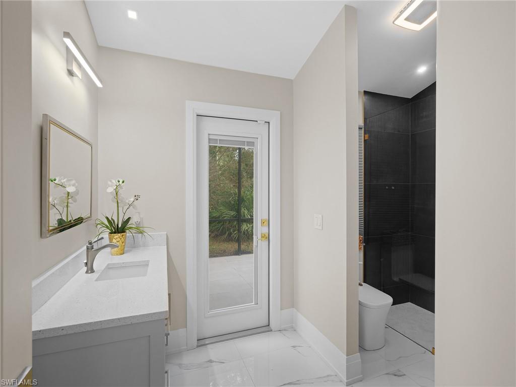 2140 Harlans Run Naples, FL 34105 - Photo 30 of 37 a bathroom with a sink a toilet and shower