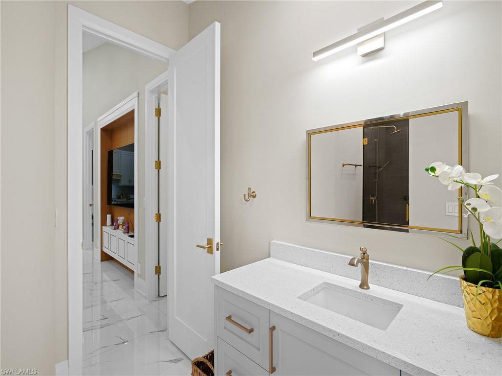 2140 Harlans Run Naples, FL 34105 - Photo 31 of 37 a bathroom with a sink and a mirror
