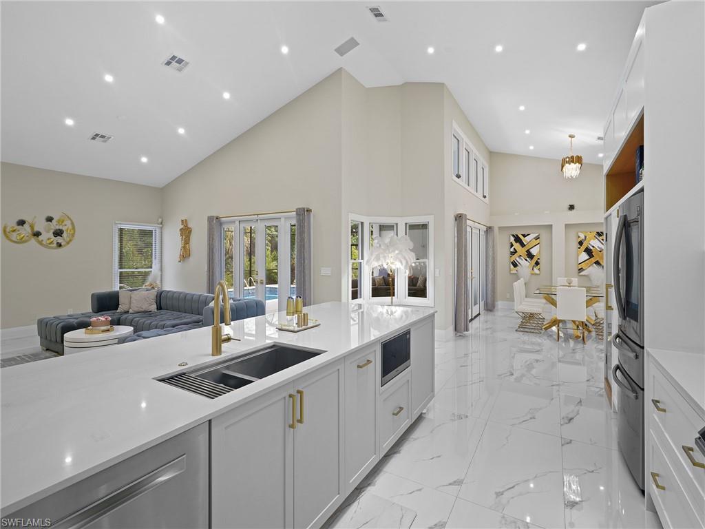 2140 Harlans Run Naples, FL 34105 - Photo 34 of 37 a large white kitchen with a large window