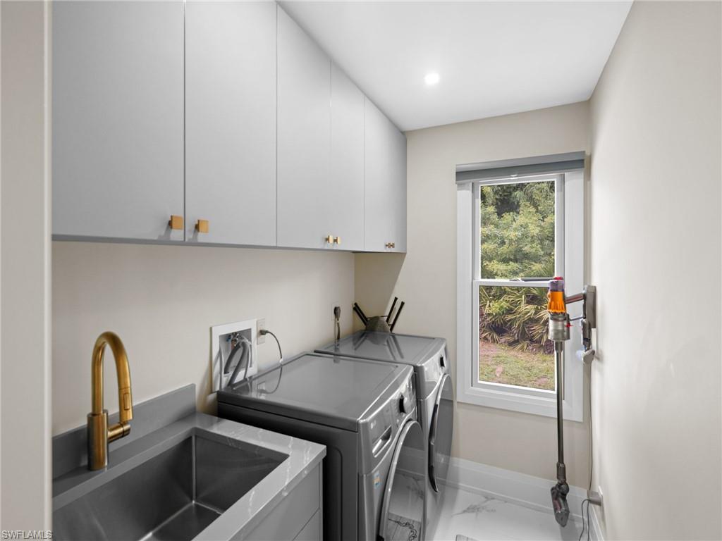 2140 Harlans Run Naples, FL 34105 - Photo 35 of 37 a kitchen with a stove and a sink