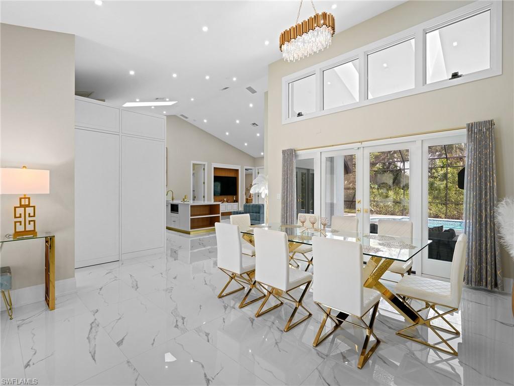 2140 Harlans Run Naples, FL 34105 - Photo 5 of 37 a living room with furniture a flat screen tv and large windows