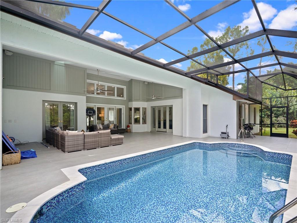 2140 Harlans Run Naples, FL 34105 - Photo 8 of 37 a living room with furniture and a fireplace