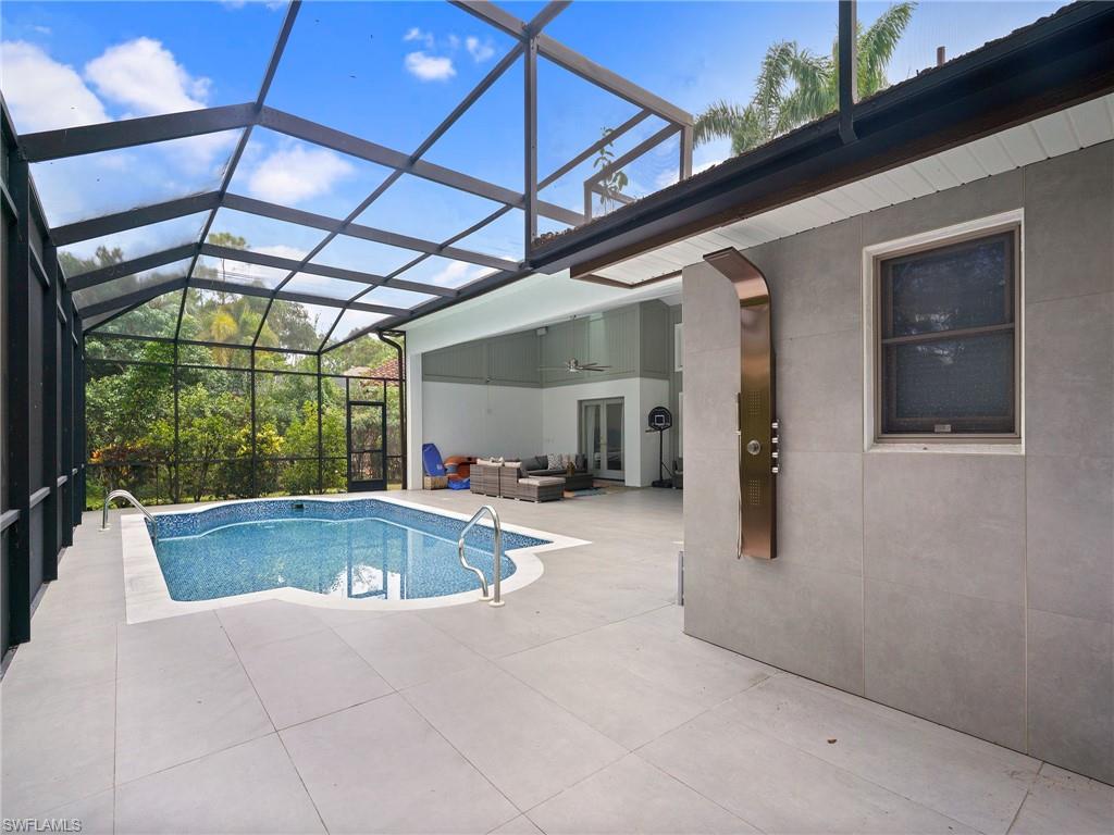 2140 Harlans Run Naples, FL 34105 - Photo 9 of 37 a view of a patio with a table and chairs