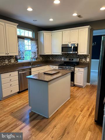 229 Barnhill Road Perkasie, PA 18944 - Photo 22 of 66 a kitchen with stainless steel appliances granite countertop wooden cabinets a refrigerator a sink a stove a microwave and wooden floors