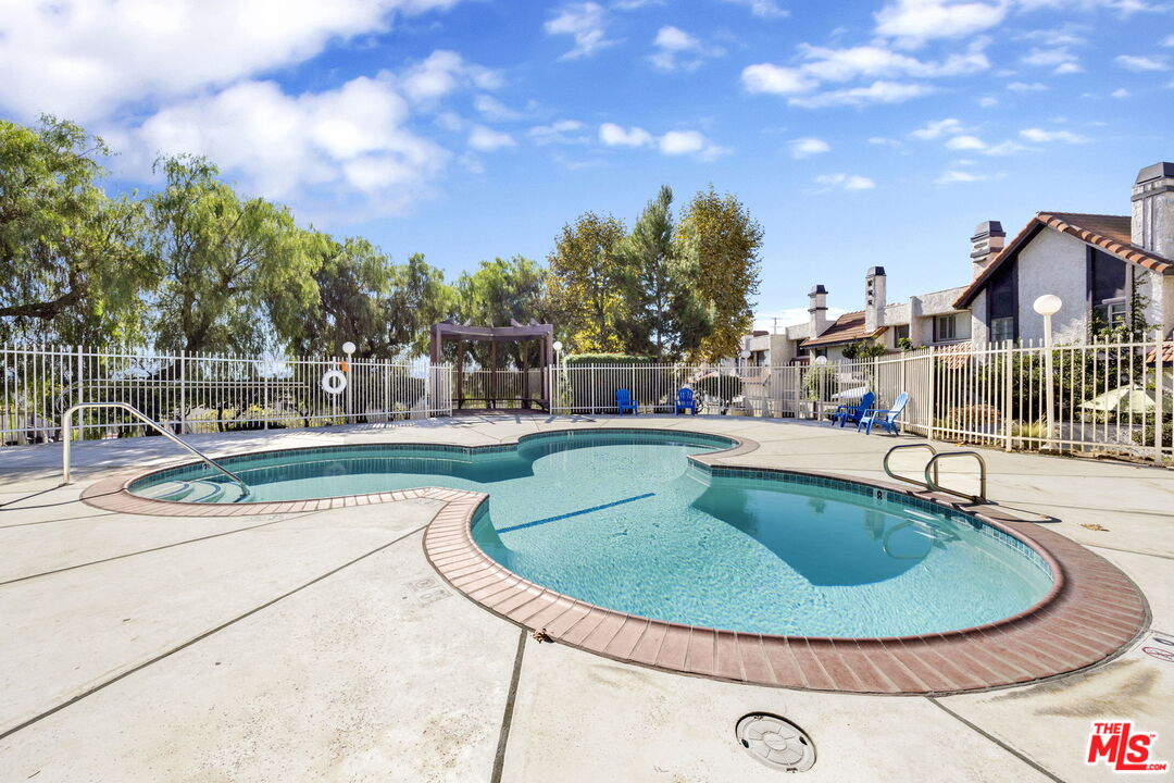 12330 Osborne Street, Unit 77 Pacoima, CA 91331 - Photo 20 of 32 a view of a swimming pool with a yard