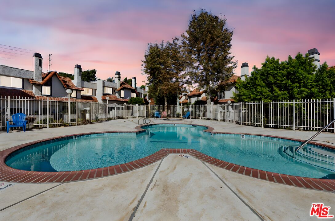 12330 Osborne Street, Unit 77 Pacoima, CA 91331 - Photo 25 of 32 a view of a swimming pool with a garden